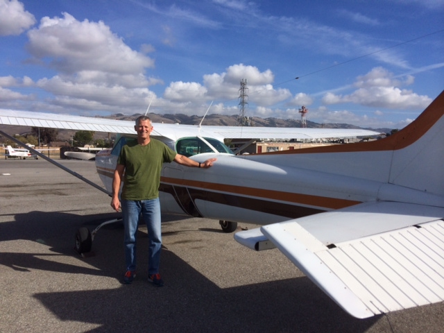 Scott Williams with our newest C172RG, N4604V, on the fleet after a successful checkride!