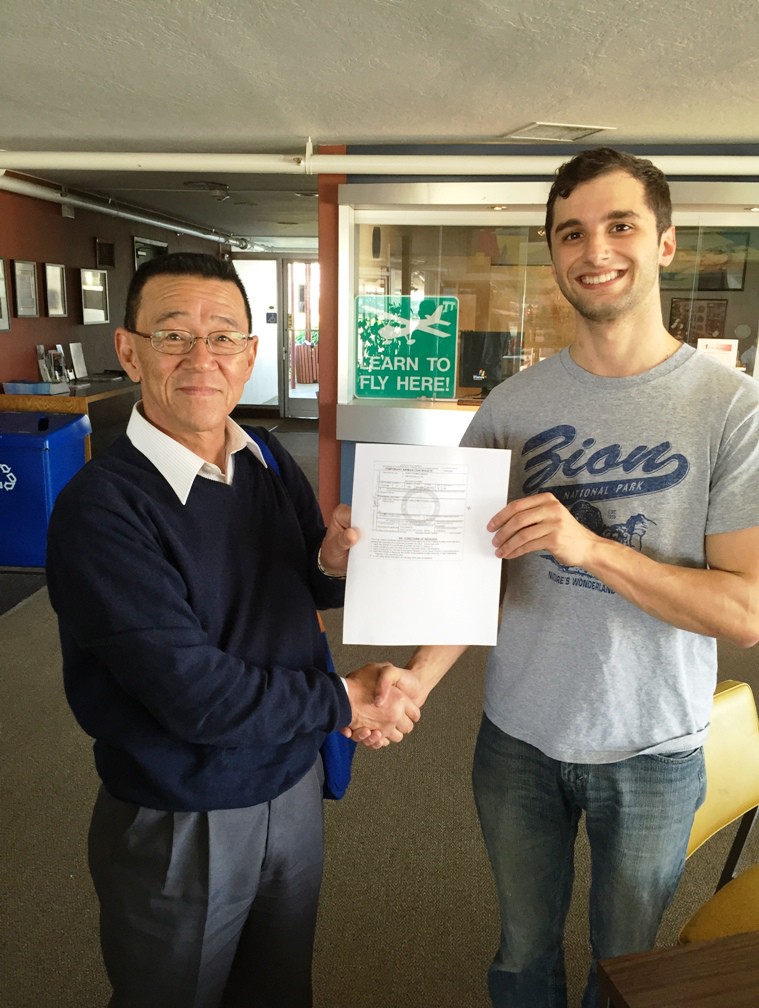 Ryan Marks receives his freshly printed pilot certificate at AeroDynamic Aviation Salinas